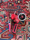 Heriz rug color reference with red and pink objects.