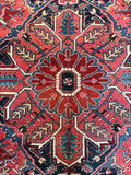 Persian Heriz rug. Oversized antique geometric wool carpet with ombré central medallion and beautifully saturated vegetable-dyed colors.