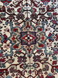 Close up of central medallion with sky blue and maroon accents.