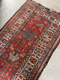 Kazak runner with bold ivory main border and graphic design.