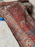 Antique Kazak runner with tribal motifs.