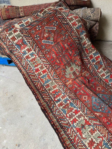 Antique Kazak runner with tribal motifs.