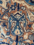 Intricate floral motifs in vintage hand knotted Kerman rug.