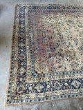 Vintage Kerman rug corner view showing floral motifs.