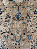 Closeup view of antique Persian rug with a blue and beige palette.