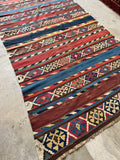 Antique kilim rug in flat weave vegetable dyed wool with horizontal stripes and scorpion motif from the 1920s.