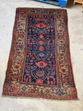 Persian Kurdish antique rug featuring tribal geometric patterns.
