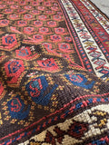 Antique Persian runner featuring rich vegetable dyed reds and blues.