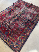 Diagonal view of the rug highlighting color variation and wear.
