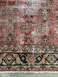 Antique Mahal rug border with winding floral vines on charcoal gray ground.