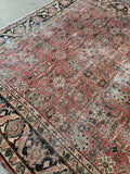 Close view of scattered wear consistent with age on an antique Mahal rug.
