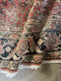 Antique Mahal rug showing floppy handle and flexible wool construction.