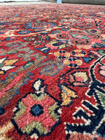 Aged Persian rug with balanced red and blue tones.