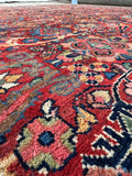 Aged Persian rug with balanced red and blue tones.