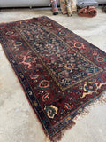 Antique 1920s Persian Malayer rug with a dark teal field and moody maroon border.