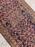 Antique Persian hallway runner showing the textured weave, aged patina, and wonderful antique character.