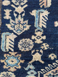 Close up of animal figures and tribal motifs on 1920s Persian Malayer rug.