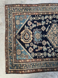 One end of Persian Malayer rug with vegetable dyed color variation and decorative motifs.