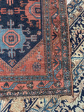 Corner detail showing wear and age on antique Persian village rug.