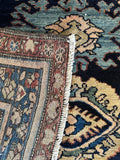 Underside detail of antique Malayer rug showing weave structure and edge condition.