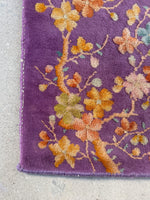 Close-up of floral corner detail with delicate branches and blossoms.