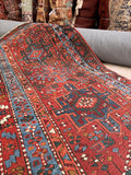 1920s geometric Persian hallway runner showing the intricate step medallions and saturated color palette.