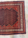 Antique Persian Malayer wool rug with geometric border, floral motifs and rich vegetable dyed colors.
