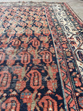 Hand knotted Persian scatter rug with navy background, paisley pattern and beautifully aged patina.