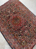 x7 antique Persian Bakhtiari rug with low pile, rich vegetable dyed colors and timeless tribal character.