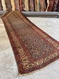 Antique Persian Bakhtiari runner, 1920s hand knotted vegetable dyed wool hallway rug with intricate lattice design, healthy low pile, and rich aged colors.