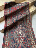 Persian Bibikabad runner with ivory border and tribal motifs framing the field.