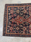 Textured surface of antique Bidjar rug showing age, patina, and wear.