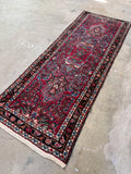 Antique 1930s Persian Dargazin runner with red field and floral sprays.