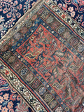 Late 19th century Persian scatter rug with coral field, vegetable dyed wool and tribal floral design.