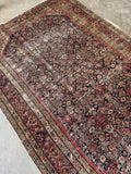 Antique Persian gallery rug. Circa 1900 Ferahan rug with a navy field, layered floral border bands, and naturally aged vegetable-dyed wool.