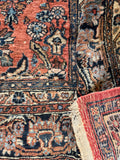 Authentic Antique Persian Rug in rare coral pink with allover floral design and beautifully preserved wool pile.