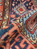 Antique Persian rug from Northwest Persia, featuring a scorpion motif on navy ground with a red tribal border.