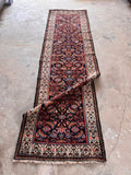 Antique Persian Herati runner rug full-length top-down shot showing the narrow design and midnight blue field.