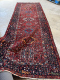 Antique geometric Persian rug. Hand knotted Heriz gallery carpet with vibrant colors, tribal motifs, and an uncommon 4'10 x 13' size.