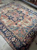 Full view of antique Persian Heriz rug with visible wear and aged patina.