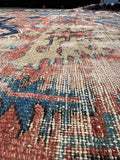 Worn low pile texture on antique Persian Heriz rug.
