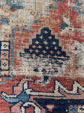 Geometric movement in antique Persian Heriz rug.