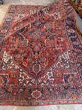 8x11 antique Persian Heriz rug with bold geometric medallion and handmade wool construction.