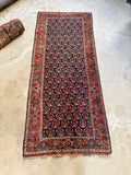 Early 20th-century Kurdish runner with colorful brush-style paisleys.