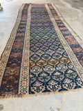 Vintage Persian hallway runner featuring color shifting lattice design in rich blues and browns.