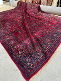 Antique Persian Lilihan rug with deep ruby red background.
