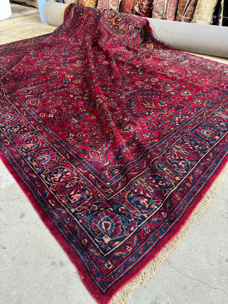 Antique Persian Lilihan rug with deep ruby red background.
