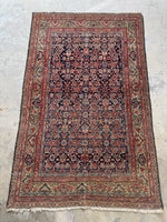 Navy field and pistachio green botanical border on antique Mahal rug.