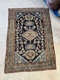 Full view of antique Persian Malayer rug from the 1920s with navy ground and Harshang pattern.