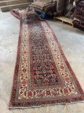 Long antique Persian runner with intricate Herati pattern and floral chain edge guards.